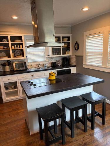 a kitchen with a large kitchen island with stools at The Gates House in Brady