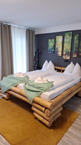 a large bed with a wooden frame in a room at Apartment Schwarzwald mit Zugang Pool und Sauna in Schönwald