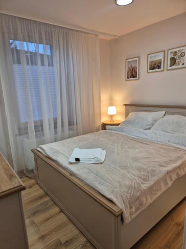 a bedroom with a bed with a tray on it at DORMAR I Apartament in Wałbrzych