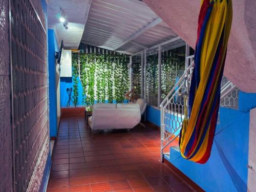 a room with a bed and a couch in a room at Hotel Casa Manzanares in Santa Marta