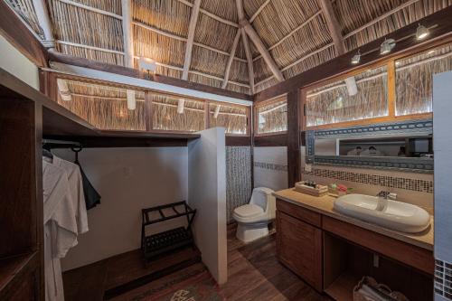 a bathroom with a toilet and a sink at Hotel Boutique Siete Lunas in Sayulita