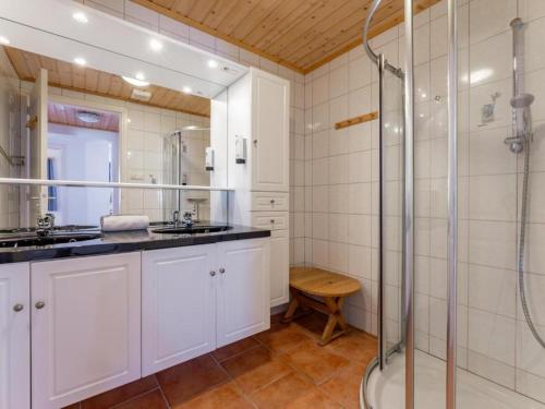 a bathroom with two sinks and a shower at Chapter Two in Niedernsill