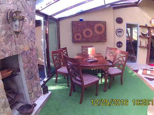 a dining room with a table and chairs and a fireplace at RELAX ECO Life Center-Khao Lak in Khao Lak