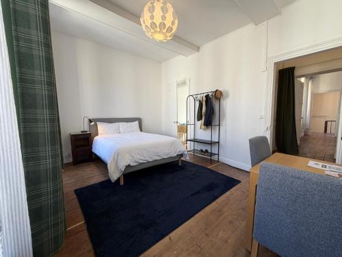 a bedroom with a bed and a room with a table at Le Douet Fleury - Chambre d'Hôtes et Gîtes in Livarot