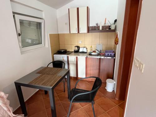 a small kitchen with a table and chairs in a room at Agniya in Seoca