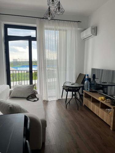 a bedroom with a bed and a table and a window at TelaValley Residence in Shalauri