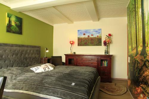 a bedroom with a bed and a wooden dresser at Ferienwohnung-Brenda in Wolfshagen