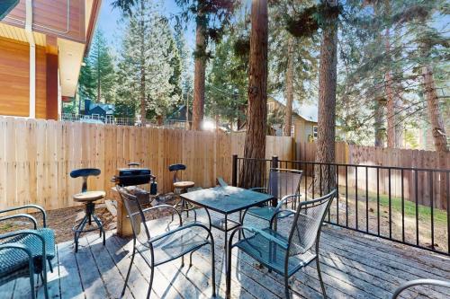 a patio with a table and chairs on a deck at Speckled Tahoe in Kings Beach