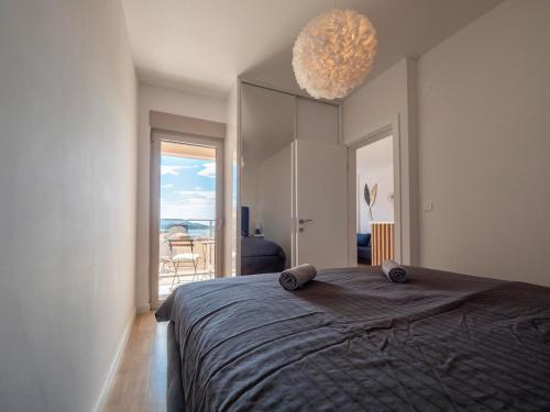 a bedroom with a large bed and a large window at Becici Chic 1BR Condo swimming pool long term in Budva