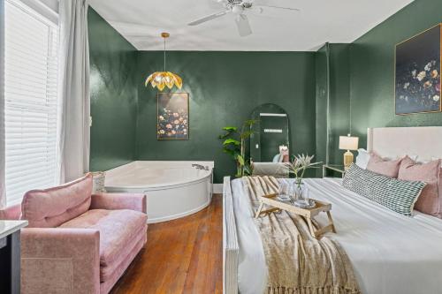 a bedroom with a tub and a bed and a couch at Southern Wind Inn in St. Augustine