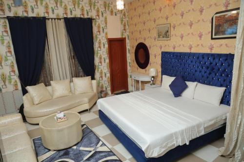 a bedroom with a large bed and a couch at Sehrai Royal Villa in Multan
