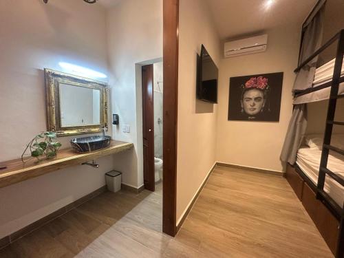 a room with a bunk bed and a hallway with a mirror at Casa Mexico Lindo - Boutique Hostel in Bacalar