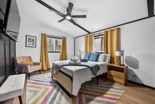 a bedroom with a bed and a ceiling fan at Radcliffe Ride Out Modern Bella Vista Retreat- Game Room, Fire Pit, Pet Friendly - Sleeps 10 in Bella Vista