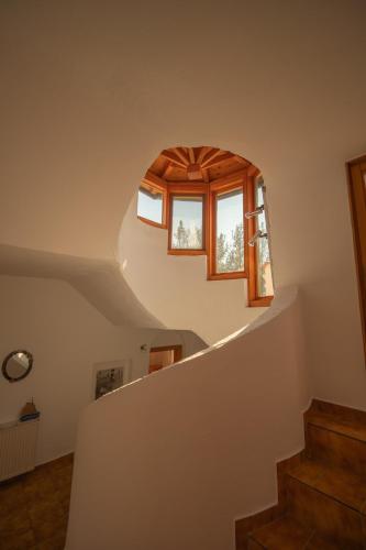 a stairway with a circular window in a house at Villa Marlene in Astris