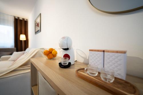 a room with a table with glasses and a blender at Secret Garden Apartman in Varaždin