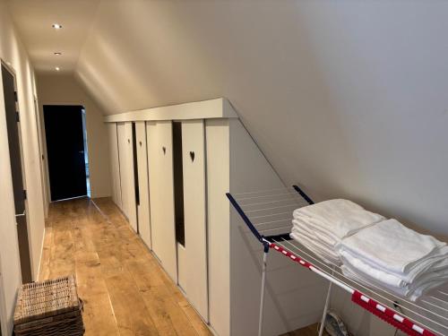 a room with a staircase with a bed and a shelf at Irene 2 in Hindeloopen