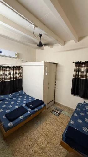 a small room with a bed and a ceiling at Rudraksh Homestay in Dwarka