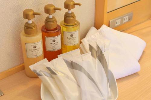 three bottles of essential oils sitting on a table at Chisun Hotel Hiroshima in Hiroshima