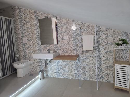 a bathroom with a sink and a toilet at Domus Anemone B&B in Avellino
