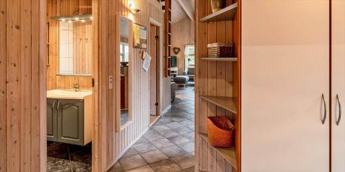 a bathroom with a sink and a mirror at VE125-Vejers-Strand-Aavej-19 in Vejers Strand