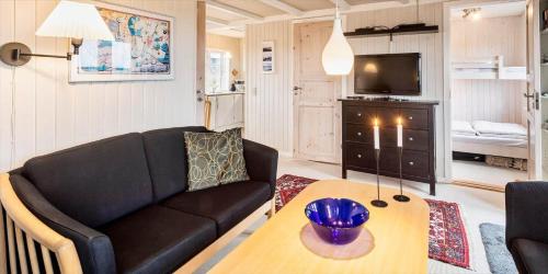 a living room with a couch and a table at VE147-Vejers-Strand-Violvej-16 in Vejers Strand