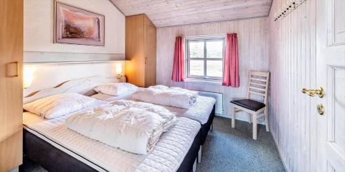 a bedroom with a large bed and a window at VE047-Vejers-Strand-Jafdalvej-91 in Vejers Strand