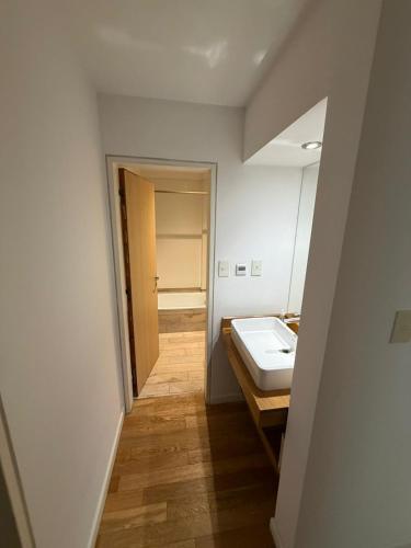 a bathroom with a sink and a mirror at Depto Altos Juramento in Salta
