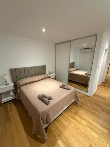 a bedroom with a bed and a large mirror at Depto Altos Juramento in Salta