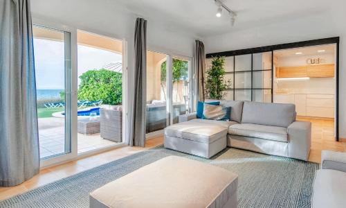 a living room with a couch and a table at Embat in Colonia de Sant Pere