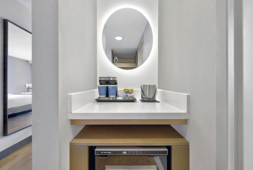 a bathroom with a sink and a mirror at DoubleTree by Hilton Davenport in Davenport
