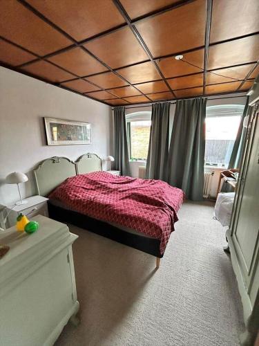 a bedroom with a bed with a red comforter at AE325-Marstal-Skovgyden-32 in Marstal