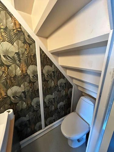 a bathroom with a staircase with a toilet in a room at AE325-Marstal-Skovgyden-32 in Marstal