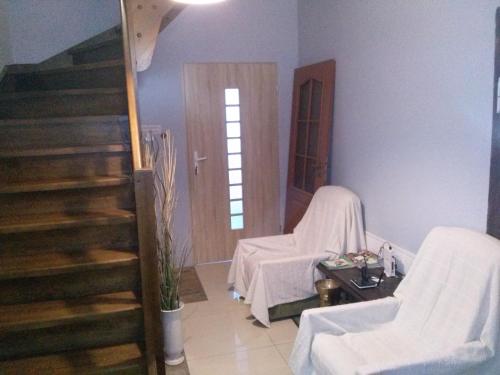 a room with a table and two chairs and stairs at Agroturystyka "U Źródła" in Milicz