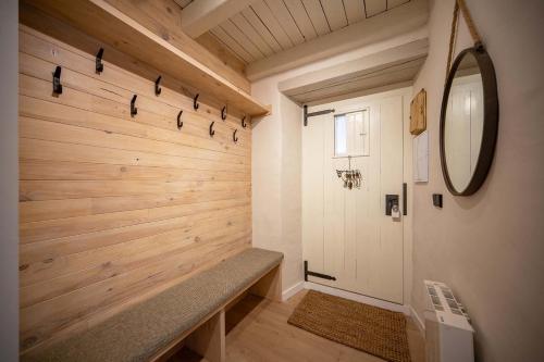 a bathroom with wooden walls and a bench in it at Arties Lodge in Arties