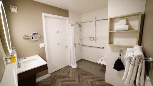 a bathroom with a shower and a sink at The Mediterranean Inn in Seattle