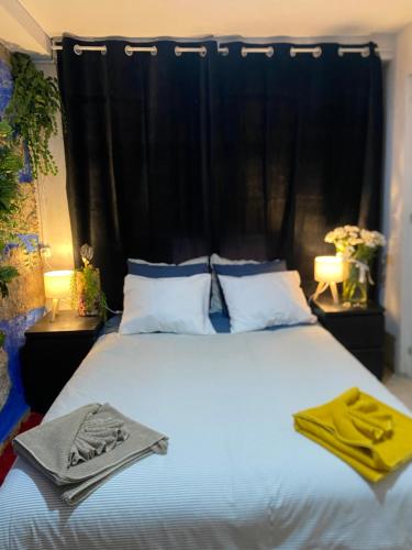 a bedroom with a large bed with towels on it at Stadium Porto Hostel in Porto