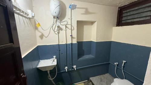 a bathroom with a toilet and a sink at Rudraksh Homestay in Dwarka