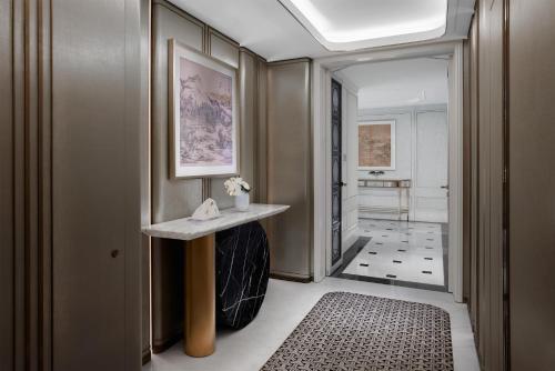 a hallway with a console table and a hallway leading to a bathroom at Conrad Shanghai in Shanghai