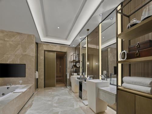 a bathroom with three sinks and two mirrors at Doubletree By Hilton Quzhou in Quzhou