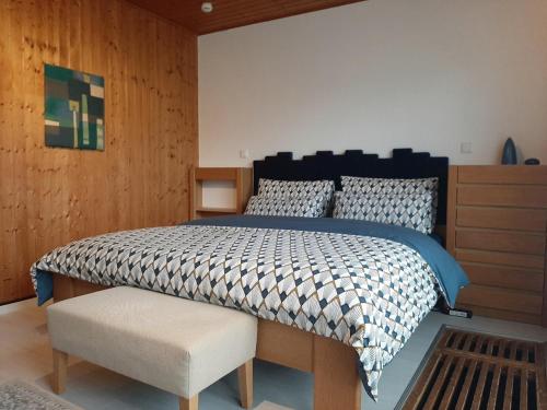 a bedroom with a large bed and a wooden wall at Hill Star in Mönchengladbach