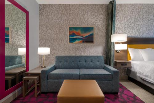 a hotel room with a couch and a bed at Home2 Suites By Hilton Redding in Redding