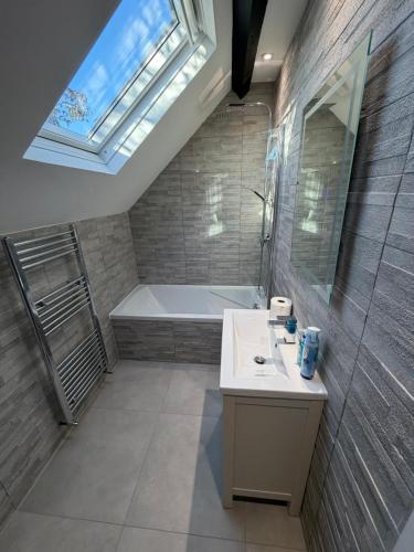 a bathroom with a tub and a sink and a shower at Windsor Flat 90C in Windsor