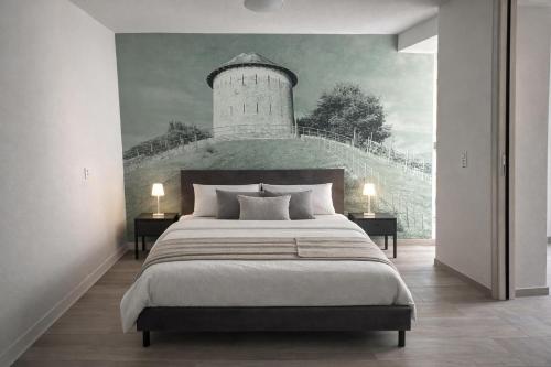a bedroom with a bed and a lighthouse mural at Tibetan BB in Bellinzona