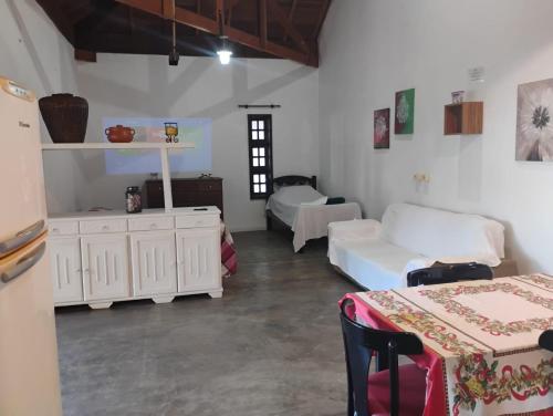 a room with two beds and two tables in it at Chalés na Montanha em Poços de Caldas in Poços de Caldas
