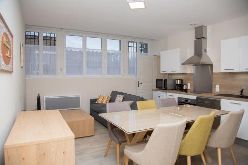 a kitchen and a living room with a table and chairs at Albiappart in Albi