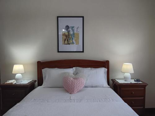 a bedroom with a heart pillow on a bed at Apart. Av. António Feijó in Ponte de Lima