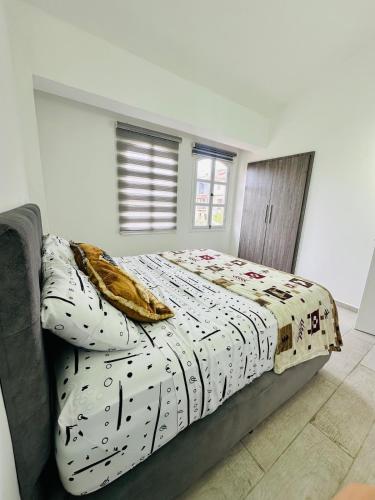 a bed with a comforter and pillows in a bedroom at Villa Corfus in Barrio El Paraíso