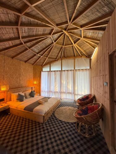 a bedroom with a large bed and a large ceiling at Chader Bari Beach Resort, Cox's Bazar in Cox's Bazar