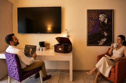 a man and a woman sitting at a table in a room at Hotel Andante in Puebla