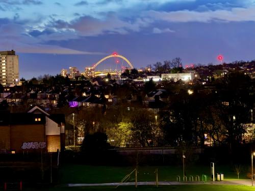 a city skyline with a ferris wheel at night at Stunning 2Bedrooms, 2Baths, Balcony, Parking in Colindale